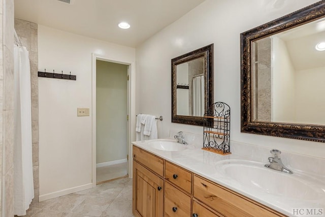 bathroom with tile patterned floors and vanity