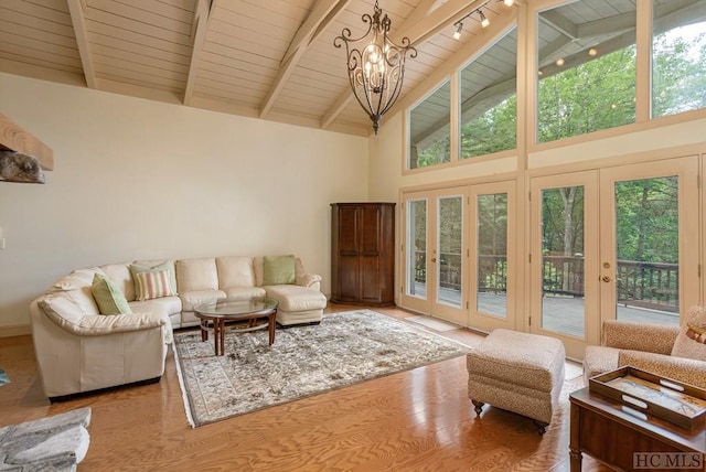 living room with a notable chandelier, hardwood / wood-style flooring, high vaulted ceiling, wood ceiling, and beam ceiling