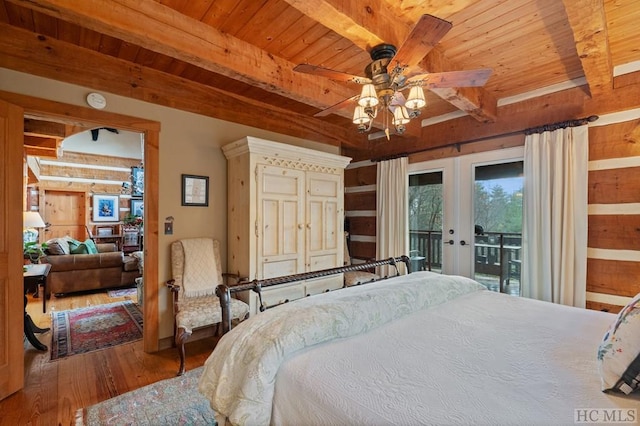 bedroom featuring beamed ceiling, wood-type flooring, access to outside, and ceiling fan