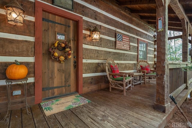 view of exterior entry featuring a porch