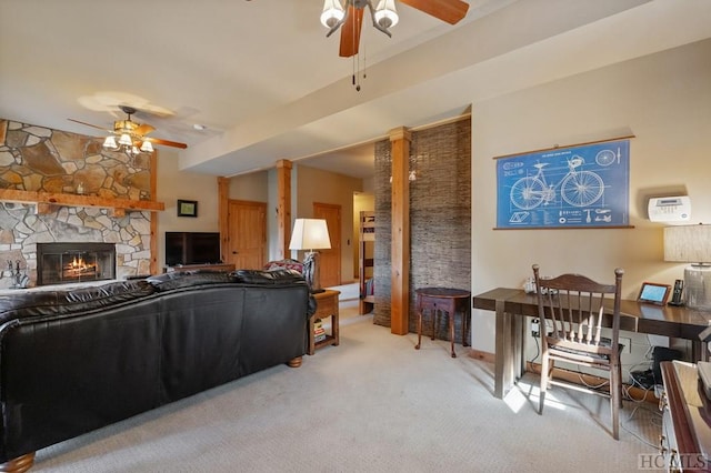 carpeted living room with a fireplace and ceiling fan