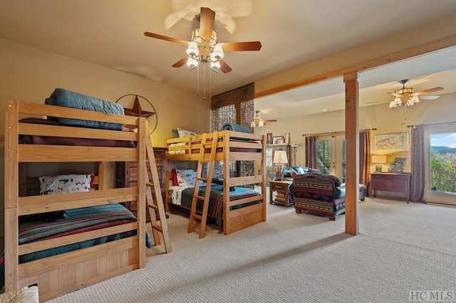 carpeted bedroom with french doors and ceiling fan