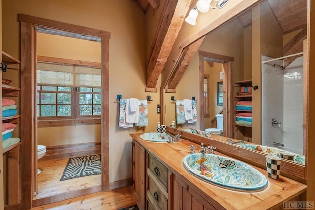 bathroom featuring lofted ceiling, toilet, a shower, vanity, and hardwood / wood-style flooring