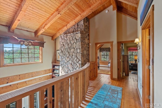 corridor with beam ceiling, high vaulted ceiling, wood ceiling, and light hardwood / wood-style floors