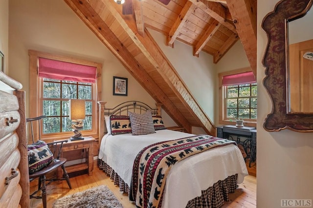 bedroom with ceiling fan, vaulted ceiling with beams, wood ceiling, and light hardwood / wood-style floors