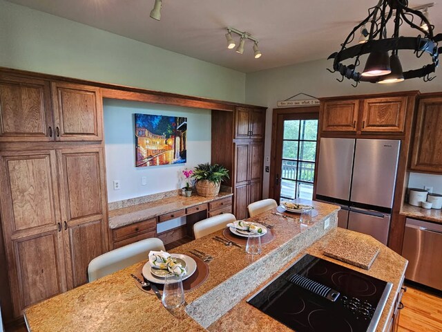 786-301 Trillium Ridge Rd Unit 301, Cullowhee, NC 28723 - kitchen featuring appliances with stainless steel finishes, light wood finished floors, and brown cabinetry