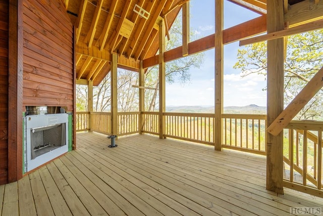 wooden terrace featuring a mountain view and a fireplace