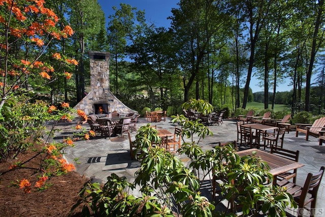 view of patio featuring an outdoor stone fireplace