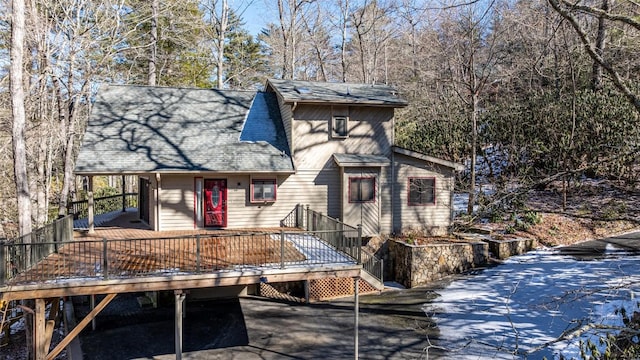 rear view of property featuring a wooden deck