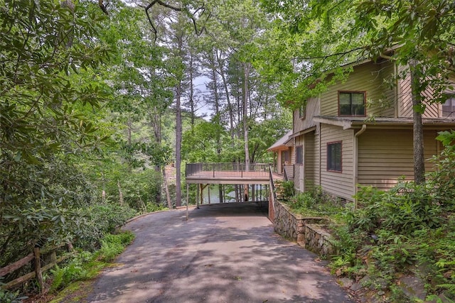 181 Hiwassee Rd, Lake Toxaway, NC 28747 - view of side of home featuring driveway, a carport, and a deck