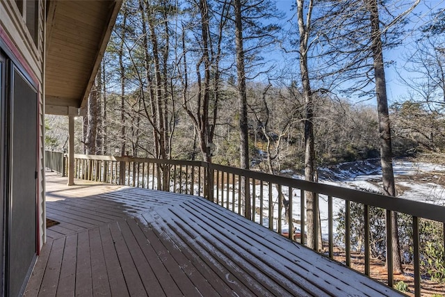 snow covered deck featuring a water view