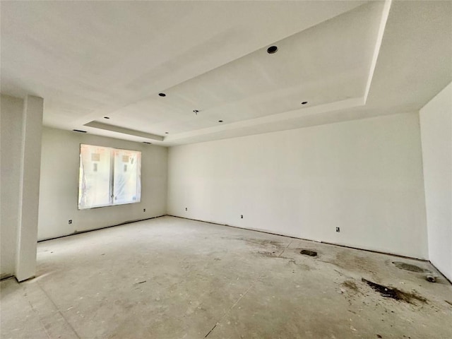 empty room with a raised ceiling