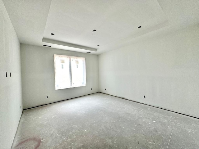 empty room featuring a raised ceiling