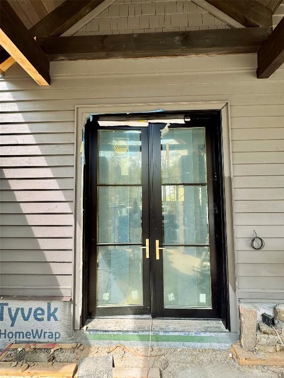 view of exterior entry featuring french doors