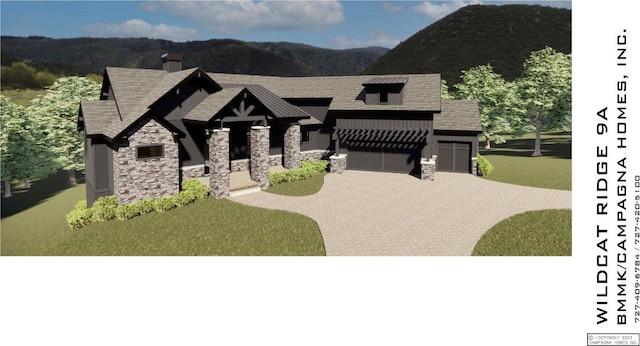 view of front of house featuring stone siding, driveway, a mountain view, and an attached garage