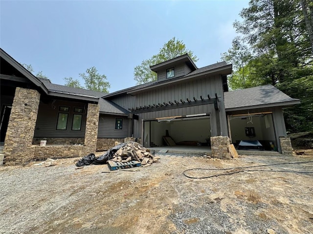 2385 Magnolia Dr, Highlands, NC 28741 - view of front facade with stone siding, board and batten siding, a garage, a shingled roof, and driveway