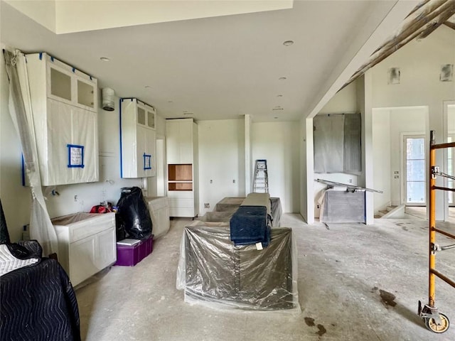 2385 Magnolia Dr, Highlands, NC 28741 - kitchen with white cabinetry, open floor plan, and concrete flooring