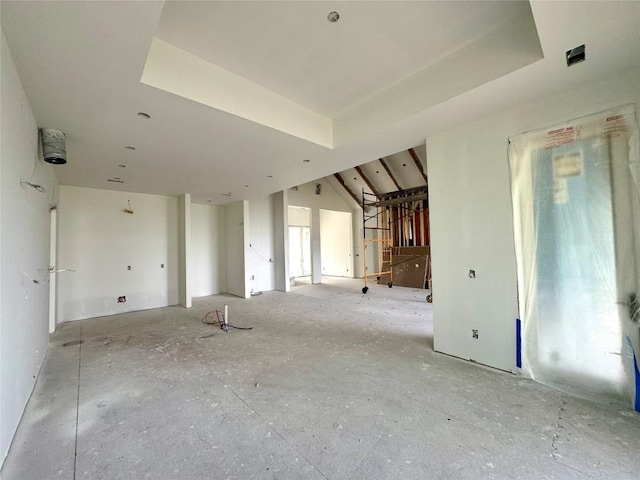 unfurnished living room with a raised ceiling