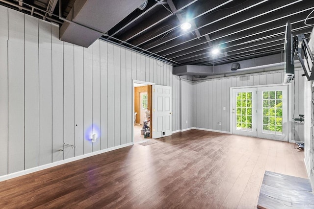 below grade area featuring wood finished floors and baseboards