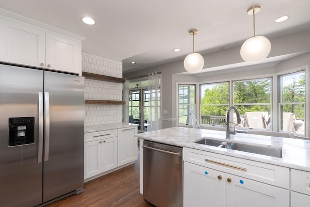 kitchen featuring appliances with stainless steel finishes, a sink, open shelves, plenty of natural light, and recessed lighting