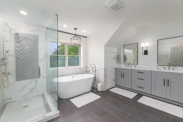 bathroom with a stall shower, a soaking tub, double vanity, recessed lighting, and tile walls