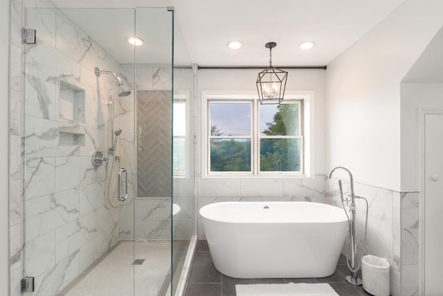 bathroom with a freestanding tub, tile walls, a shower stall, tile patterned flooring, and recessed lighting