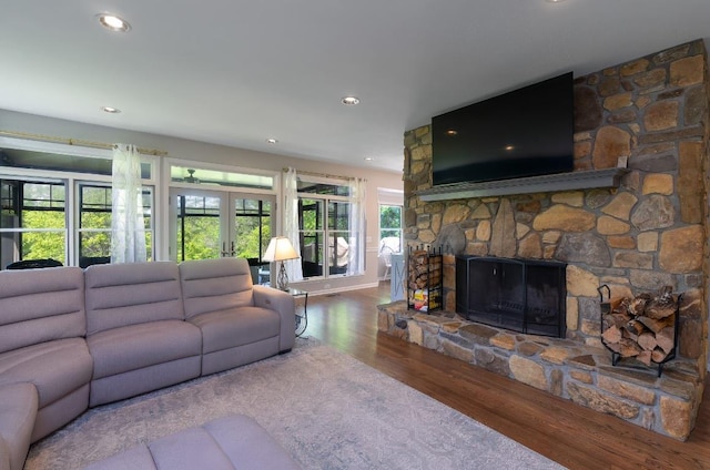 living room with wood finished floors, a fireplace, and recessed lighting