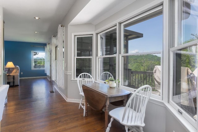 dining space with wood finished floors, baseboards, and recessed lighting