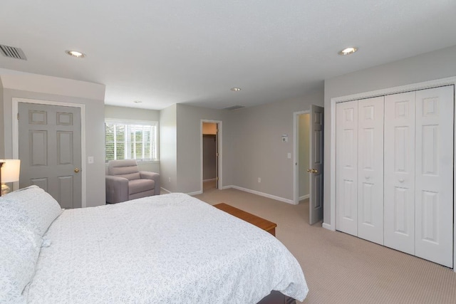 bedroom with light colored carpet, baseboards, a closet, and recessed lighting