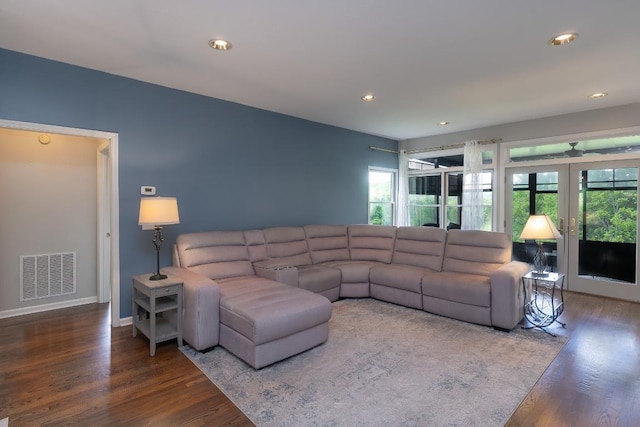 living area featuring wood finished floors, plenty of natural light, french doors, recessed lighting, and baseboards