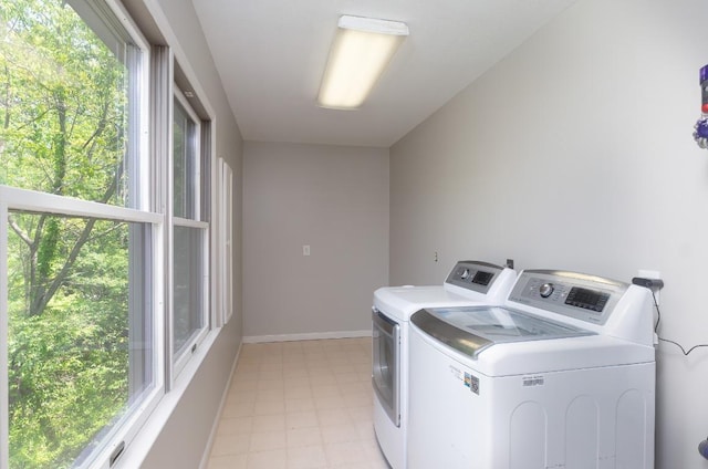 laundry room featuring washer and dryer and baseboards