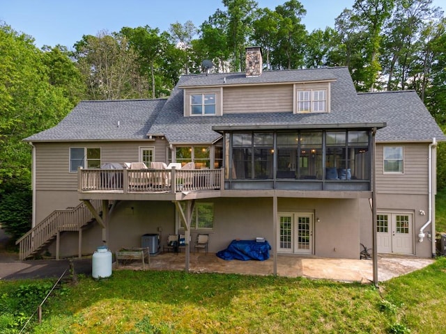 rear view of property featuring a sunroom, french doors, cooling unit, a chimney, and a patio area