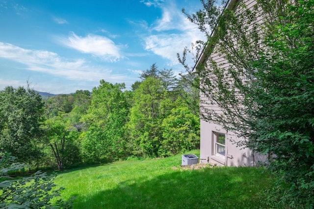 view of yard with a view of trees