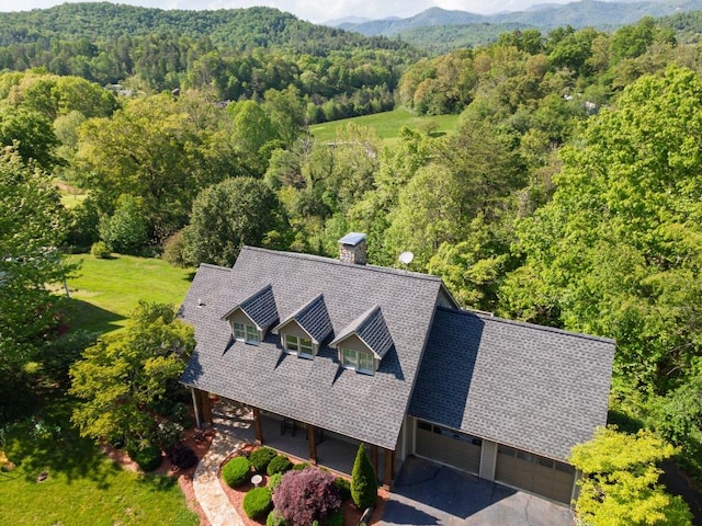 view from above of property with a heavily wooded area and mountains