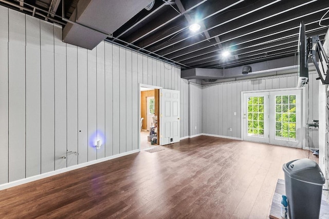 basement featuring wood finished floors and baseboards
