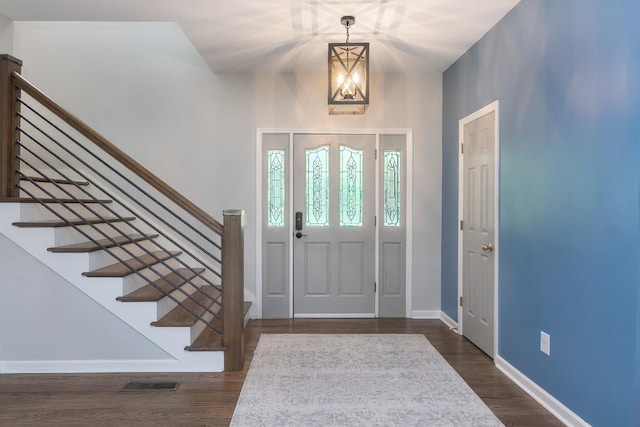 entryway with baseboards, stairway, and dark wood-style flooring