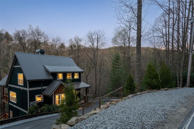 1018N Norton Rd, Cashiers, NC 28717 - view of front facade featuring metal roof, a wooded view, and a chimney