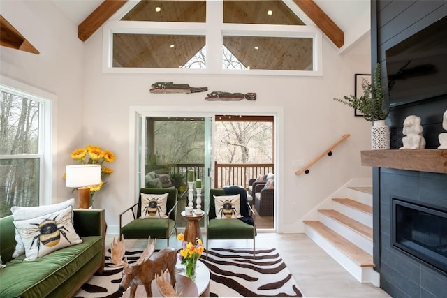 1018N Norton Rd, Cashiers, NC 28717 - living room with beamed ceiling, stairway, wood finished floors, high vaulted ceiling, and a glass covered fireplace