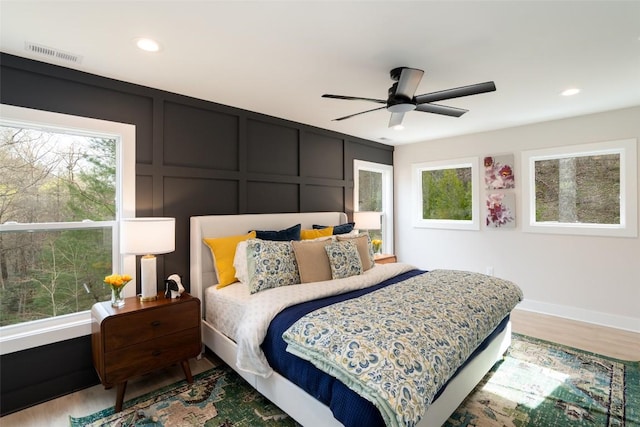 1018N Norton Rd, Cashiers, NC 28717 - bedroom with wood finished floors, a decorative wall, recessed lighting, and a ceiling fan