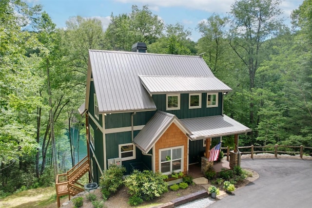 1018N Norton Rd, Cashiers, NC 28717 - view of front of property with stairs, covered porch, a metal roof, a chimney, and a wooded view