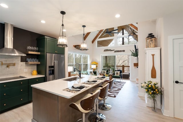 1018N Norton Rd, Cashiers, NC 28717 - kitchen featuring green cabinetry, high quality fridge, a sink, wall chimney exhaust hood, and black electric stovetop
