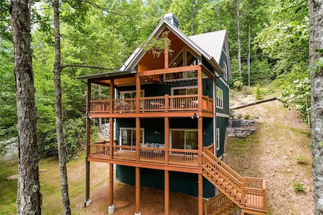 1018N Norton Rd, Cashiers, NC 28717 - back of house featuring a deck, a view of trees, a metal roof, and stairs
