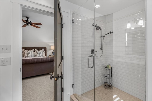 bathroom with a shower with shower door and ceiling fan