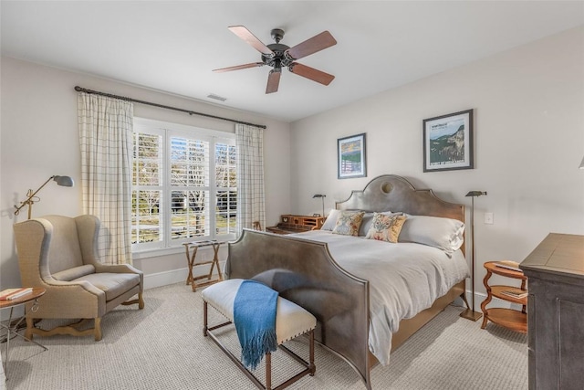 bedroom featuring ceiling fan and light carpet