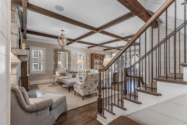 living room with coffered ceiling, dark hardwood / wood-style flooring, beamed ceiling, and a chandelier