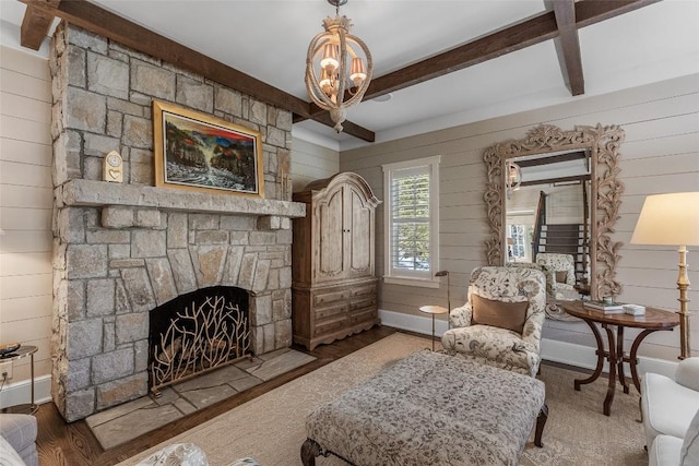 living room with beamed ceiling, a fireplace, dark hardwood / wood-style flooring, and wooden walls