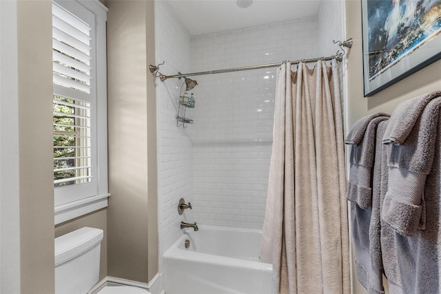 bathroom featuring shower / bath combo and toilet