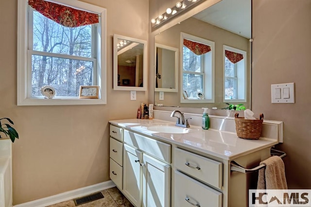 bathroom featuring tile patterned floors, vanity, visible vents, and baseboards