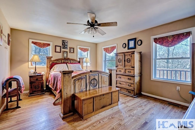 bedroom with light wood-style flooring, baseboards, a ceiling fan, and visible vents
