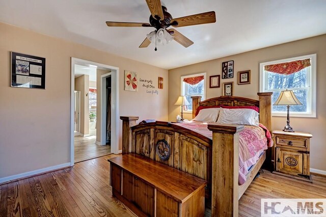 bedroom featuring baseboards, ceiling fan, and hardwood / wood-style flooring
